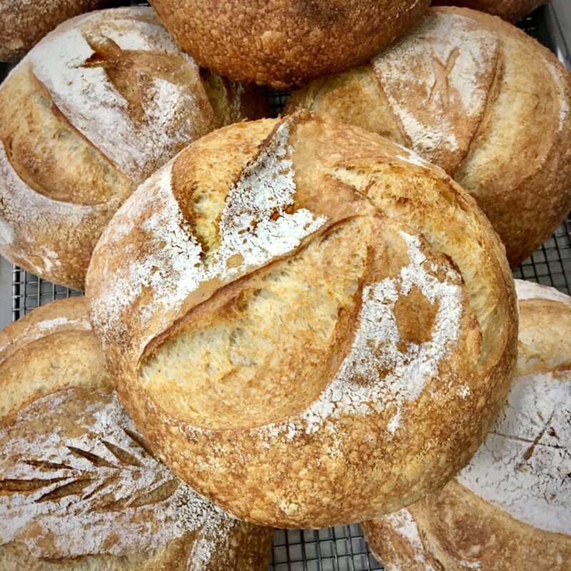 multiple loaves of sourdough bread stacked