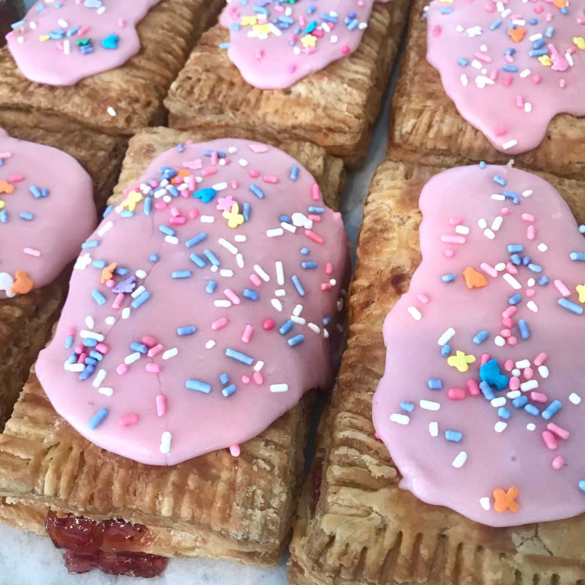 strawberry poptart with pink frosting and multicolored sprinkles